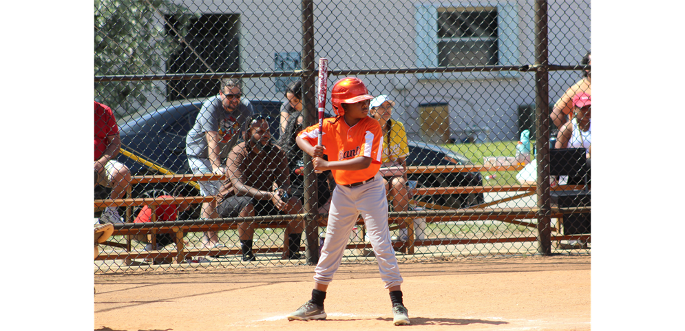 one player from Team Giants (minor division) ready to hit the ball out of this park